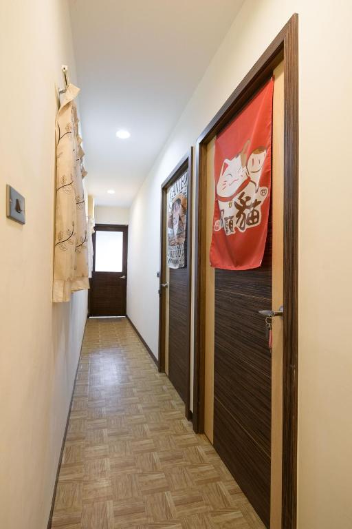 a hallway with a door and a flag on the wall at 羅東小宅一生 in Luodong