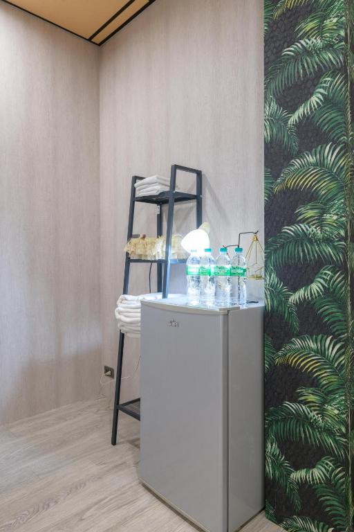 a counter with bottles of water on it next to a chair at 羅東小宅一生 in Luodong