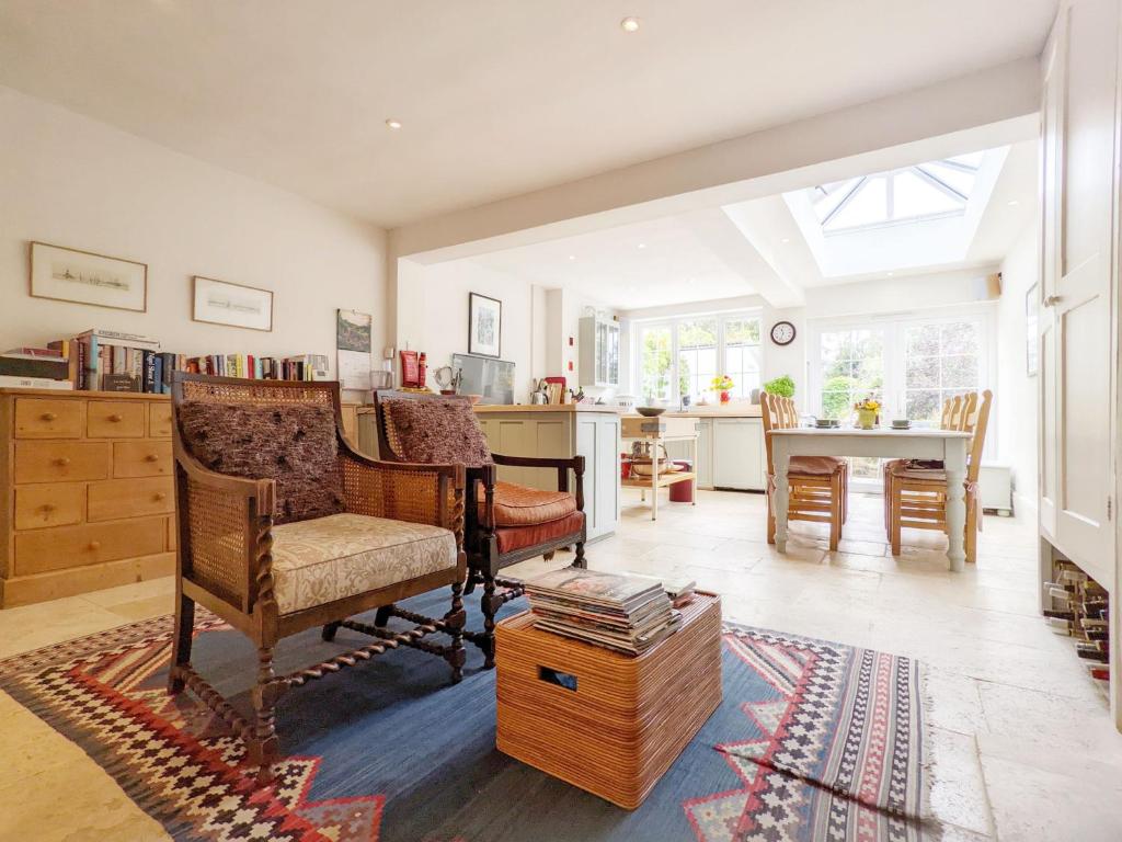 a living room with a chair and a table at Dolphin Cottage - Hayling Island in South Hayling