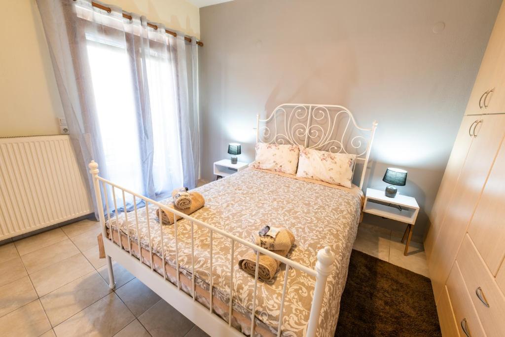 a bedroom with a white bed and a window at Muses old town ioannina Urania in Ioannina