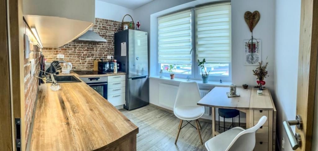 a kitchen with a wooden counter and a table at Severan New Appartement 1 in Martin