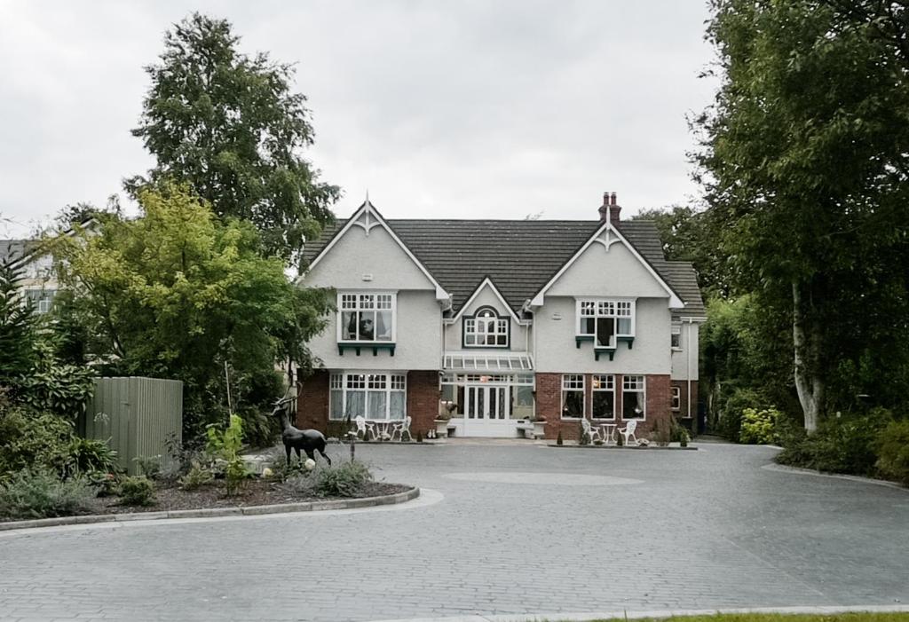 a large house with a dog in front of it at Herbert House in Killarney