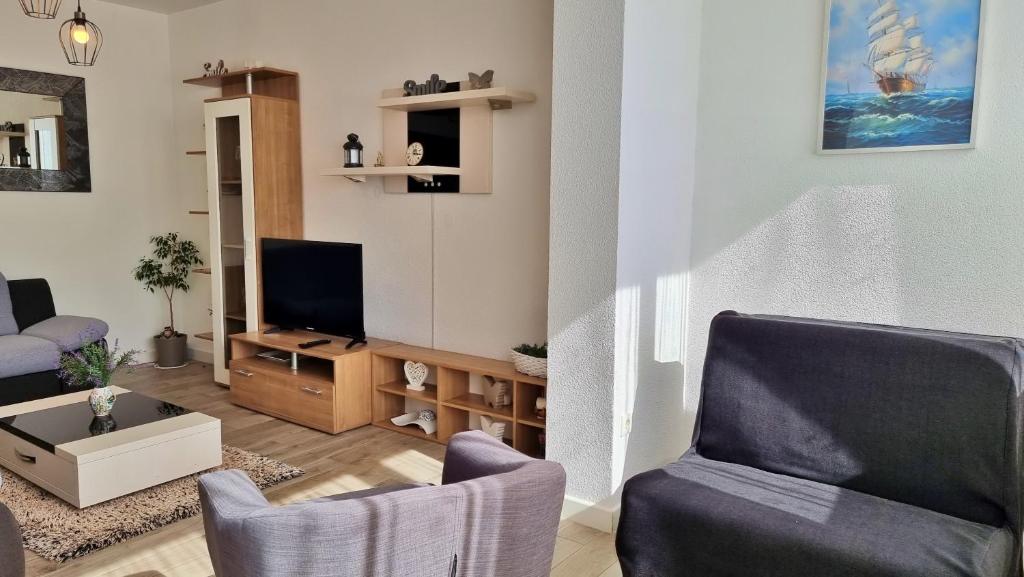 Televízia a/alebo spoločenská miestnosť v ubytovaní Apartments Slado