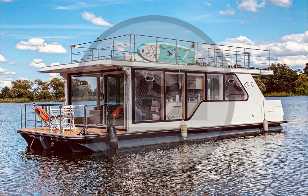 a boat is docked on the water at Awesome Ship In Neuruppin With Kitchen in Neuruppin
