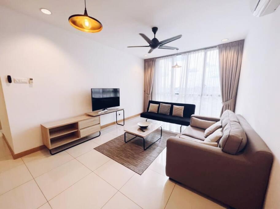 a living room with a couch and a tv at [PROMO]Connected train 2 Bedrooms - Above Mall(25) in Kuala Lumpur