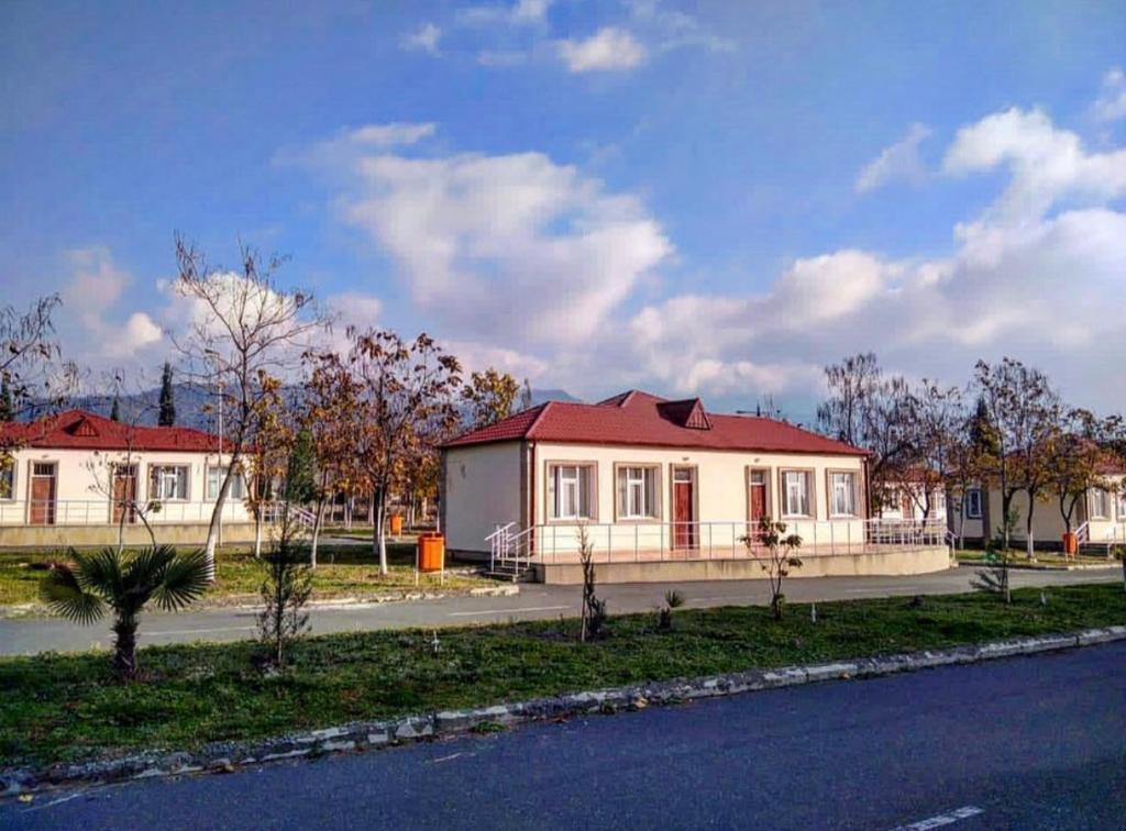 a house with a red roof on the side of the road at Balakan Olympic Villas at Olympic Sport Complex in Balakǝn