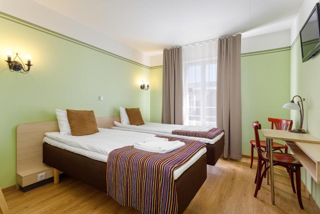 Postel nebo postele na pokoji v ubytování Koidulapark Hotell