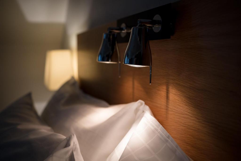 Postel nebo postele na pokoji v ubytování Grand Hotel Falkenberg