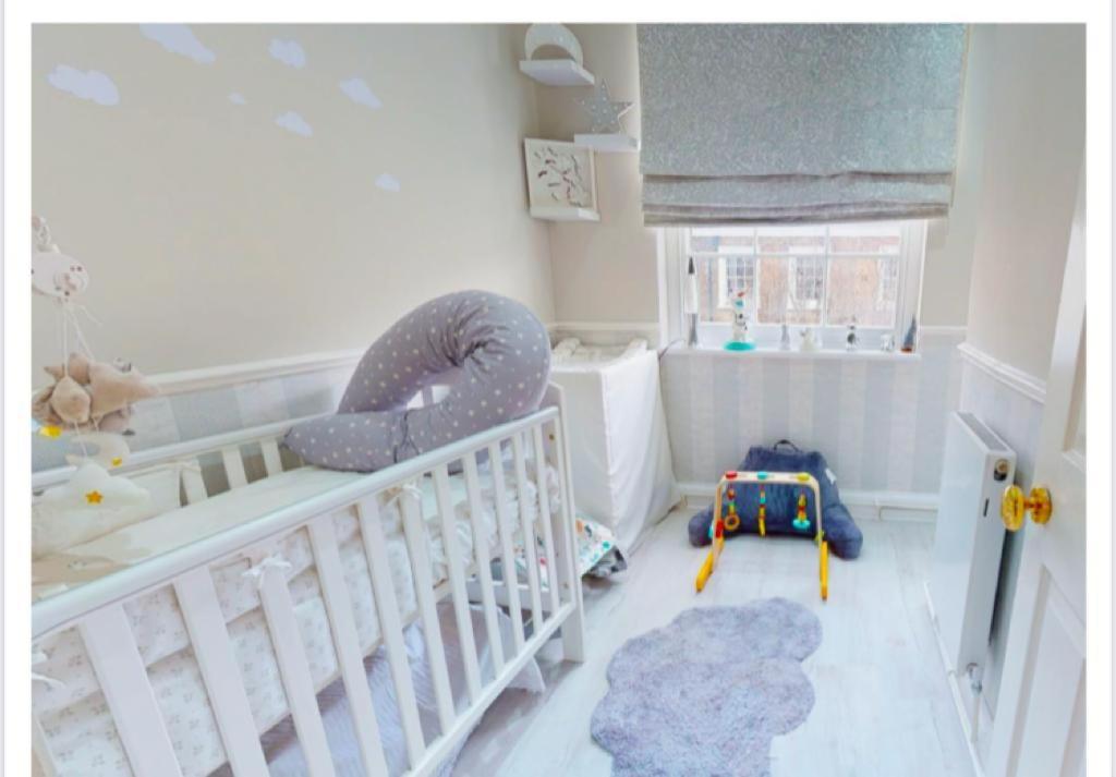 a baby room with a crib and a room with at 4 Bedrooms Villa, Hugh Street Central London in London