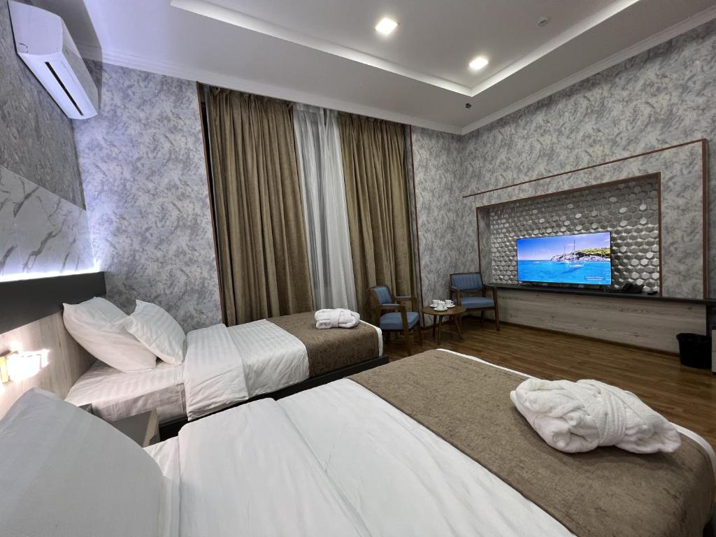 Postel nebo postele na pokoji v ubytování Ada Hotel