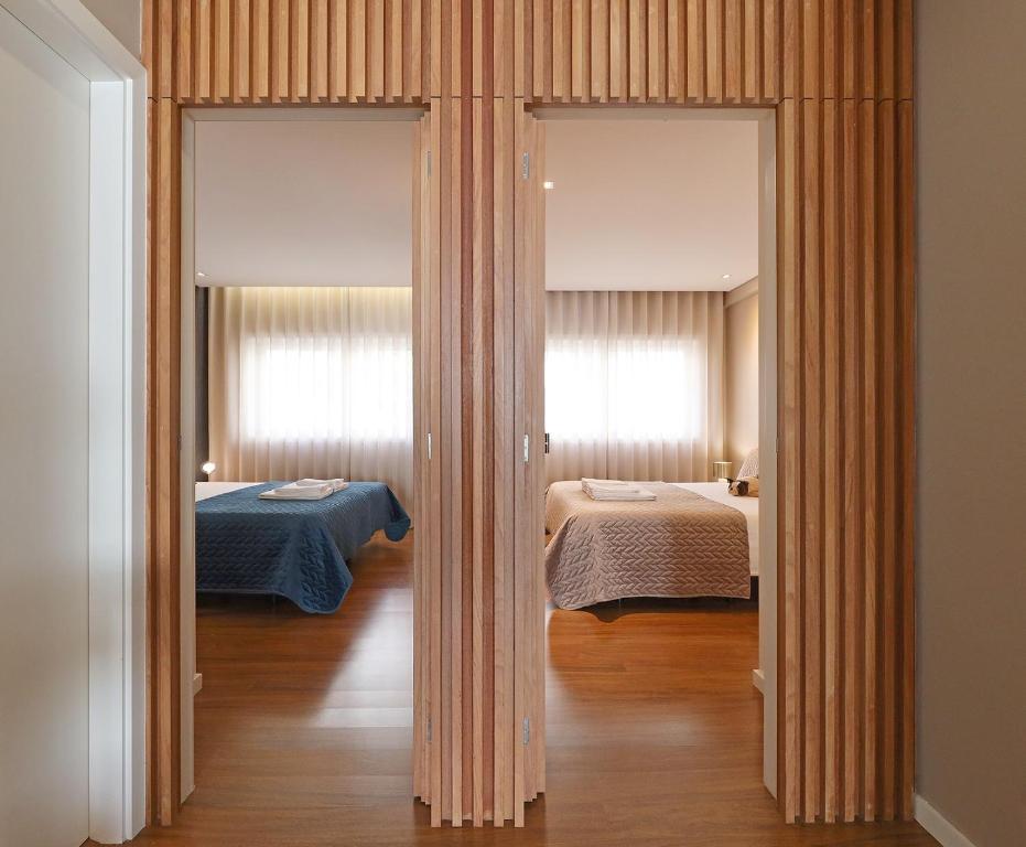 a room with two beds and two windows at Music Apartment I in Porto