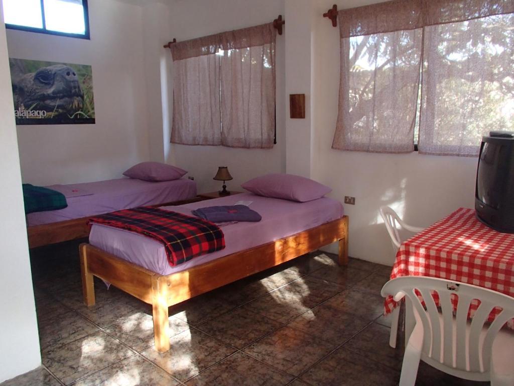 Postel nebo postele na pokoji v ubytování Hostal Suiza