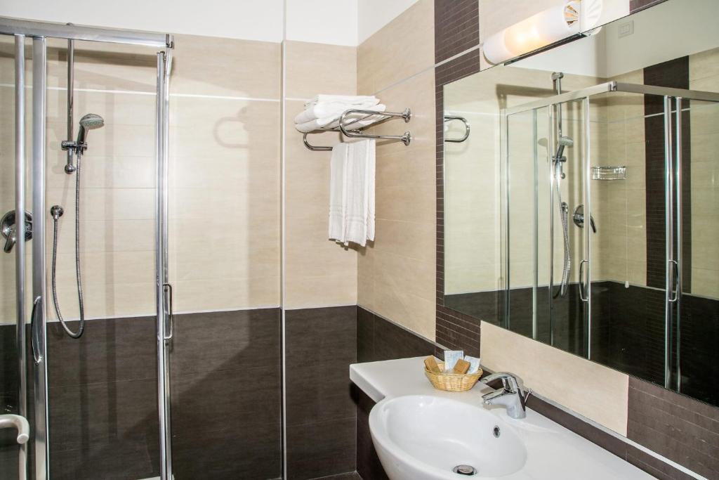 a bathroom with a shower, sink, and toilet at Hotel Spazio Residenza in Pescara