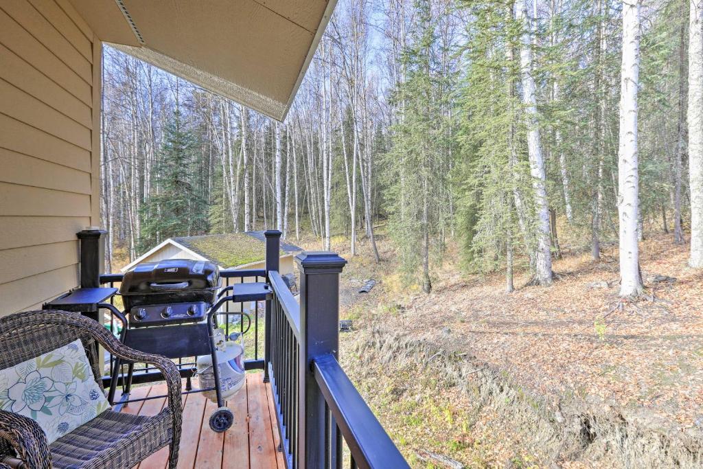 a porch with a chair and a grill on a house at Convenient Fairbanks Guest Suite with Grill! in Fairbanks
