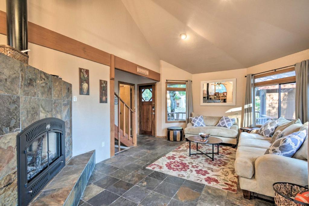 a living room with a fireplace and a couch at Deck + Grill: Mtn Haven in Stanislaus Nat'l Forest in Arnold