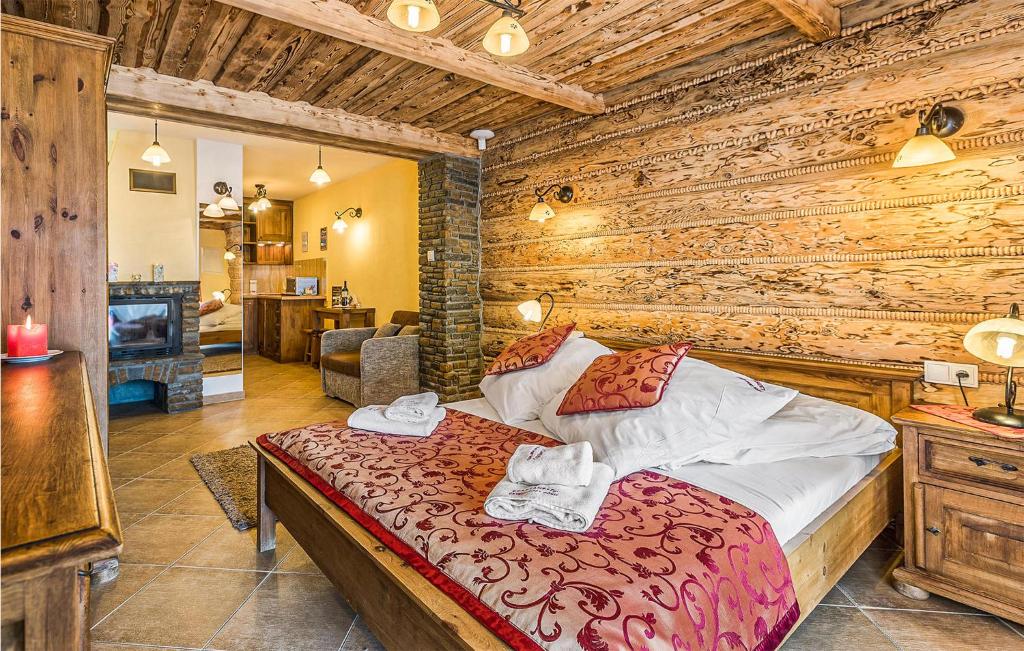 ein Schlafzimmer mit einem Bett in einem Zimmer mit Holzwänden in der Unterkunft Dolina Koscieliska in Kościelisko