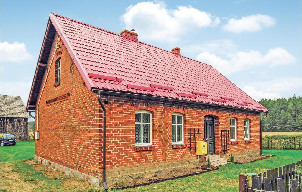 a red brick building with a red roof at Holiday Home Cekcyn Ul Lesna in Cekcyn