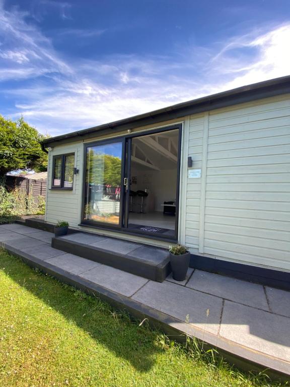 a mobile home with a sliding glass door at Stonebury Lodge in Coventry
