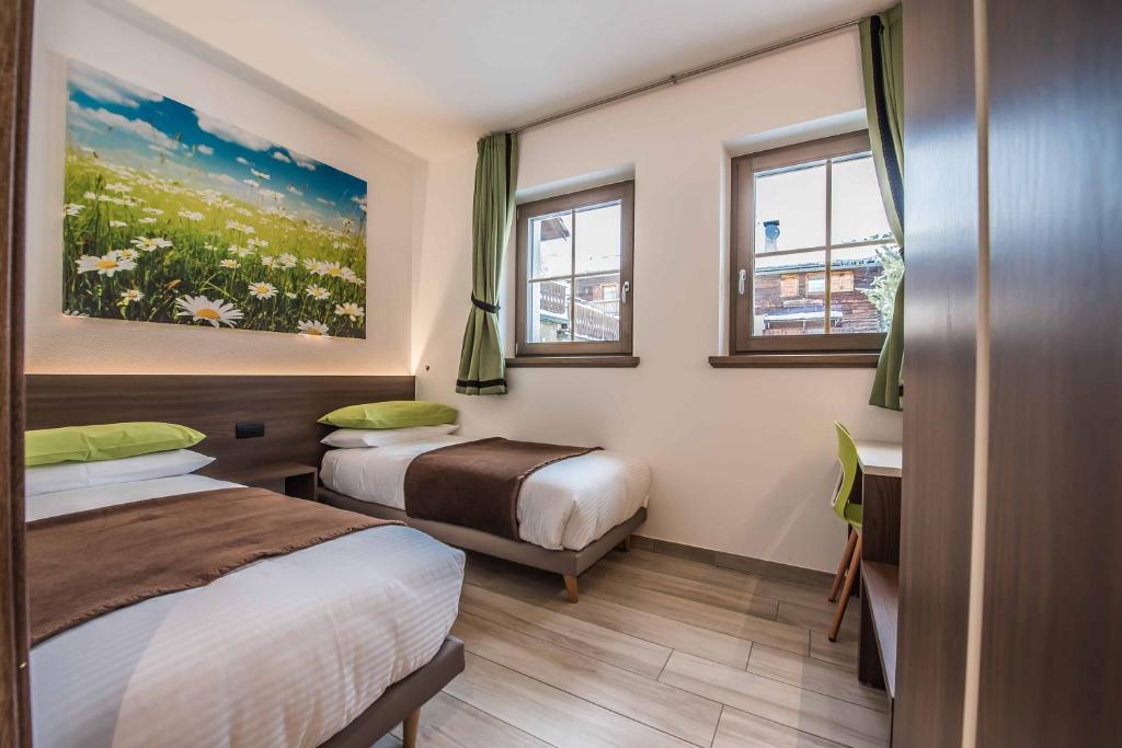 A bed or beds in a room at Chalet 4 Stagioni