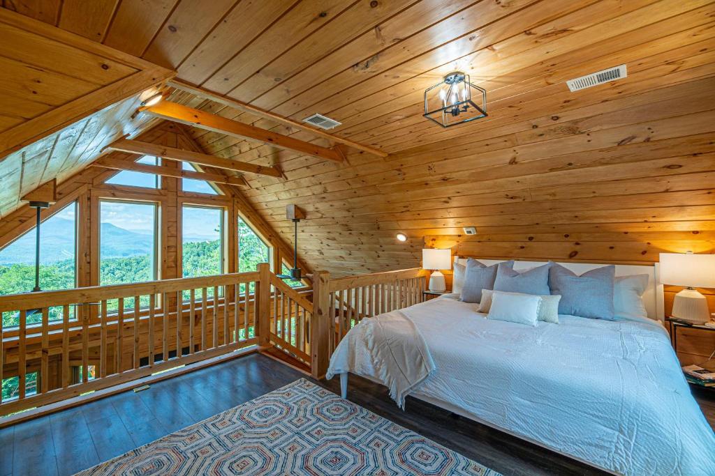 a bedroom with a bed in a wooden cabin at Mountain Mist in Gatlinburg