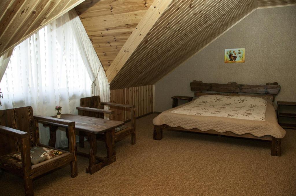 Postel nebo postele na pokoji v ubytování Polyanskiy Zamok