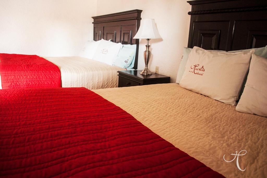 Postel nebo postele na pokoji v ubytování Hotel Colonial