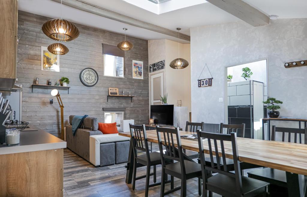 a kitchen and living room with a table and chairs at Chambre d'hôte et gîte chez Thomas et John in Verdun-sur-Meuse