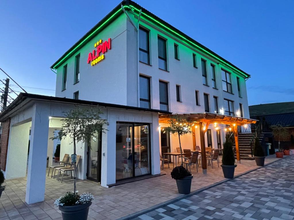 a white building with a sign on the side of it at ALPIN rooms in Topliţa