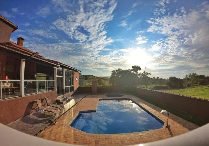 a swimming pool on the patio of a house at Casa de Campo Pardinho Eco Ninho Verde 2 in Pardinho