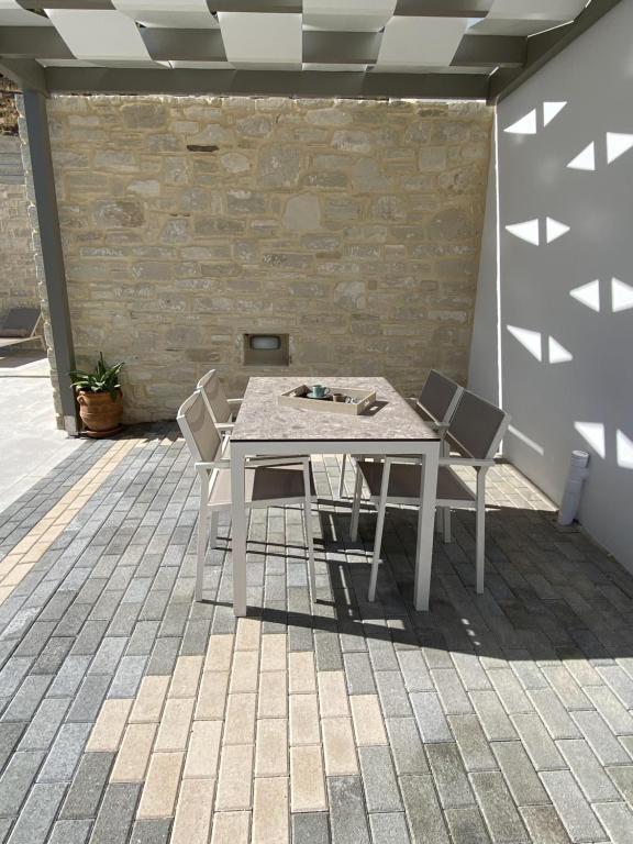 a white table and chairs on a patio at Matala Prime Villas in Matala