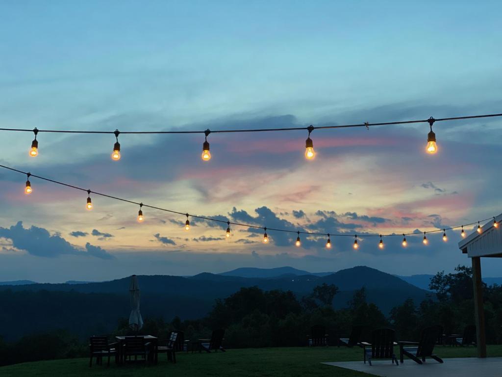 a string of lights with a view of the mountains at A Suite with a View + Wine in Mount Airy