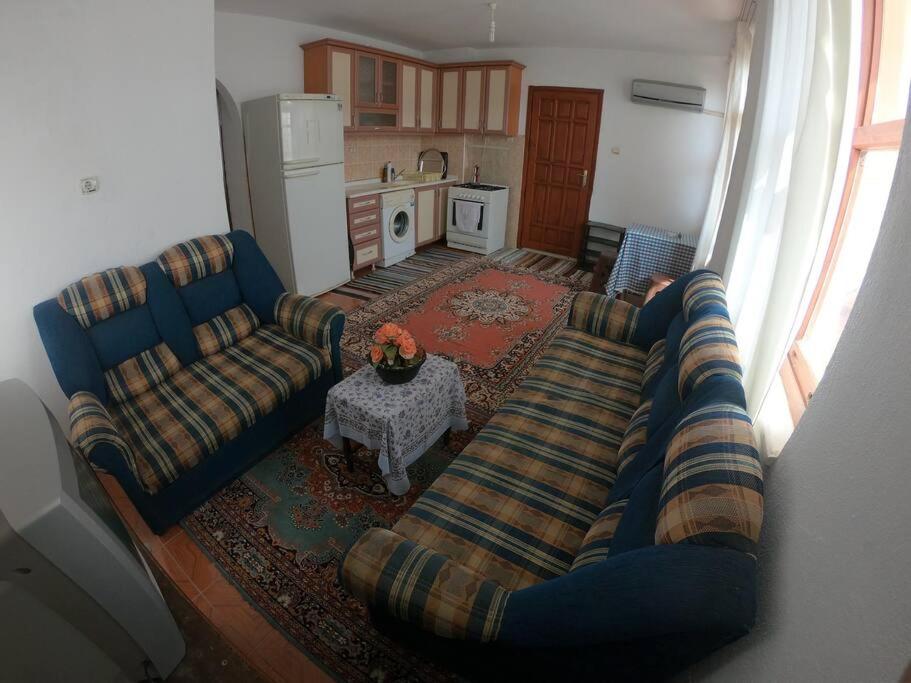 a living room with two couches and a table at Gazipasa/Alanya Airport Apt 5minBEACH/5minAIRPORT in Gazipasa