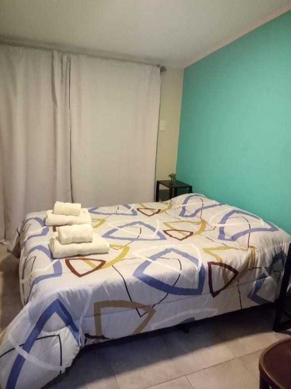 a bedroom with a bed with towels on it at San Rafael Ciudad in San Rafael
