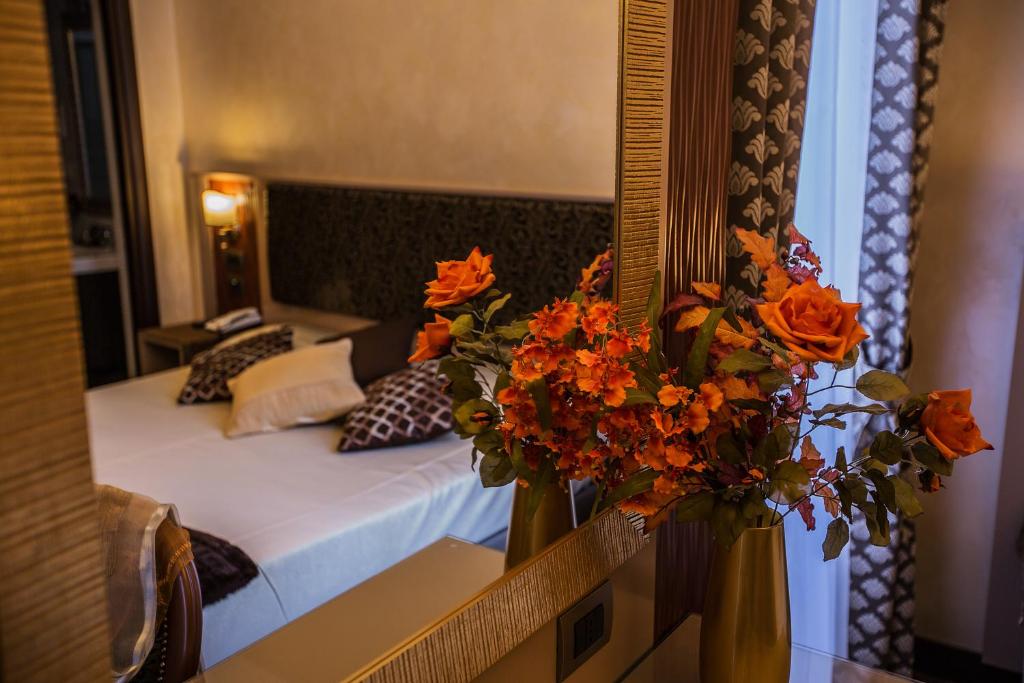 Postel nebo postele na pokoji v ubytování Hotel Romano