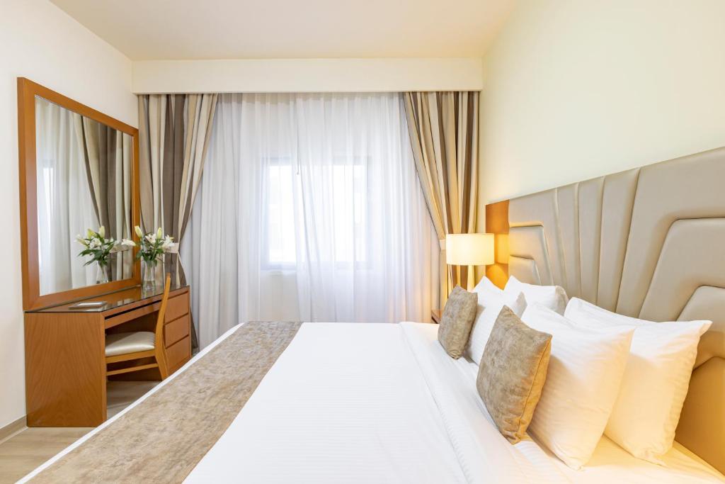 Postel nebo postele na pokoji v ubytování Golden Sands Suites