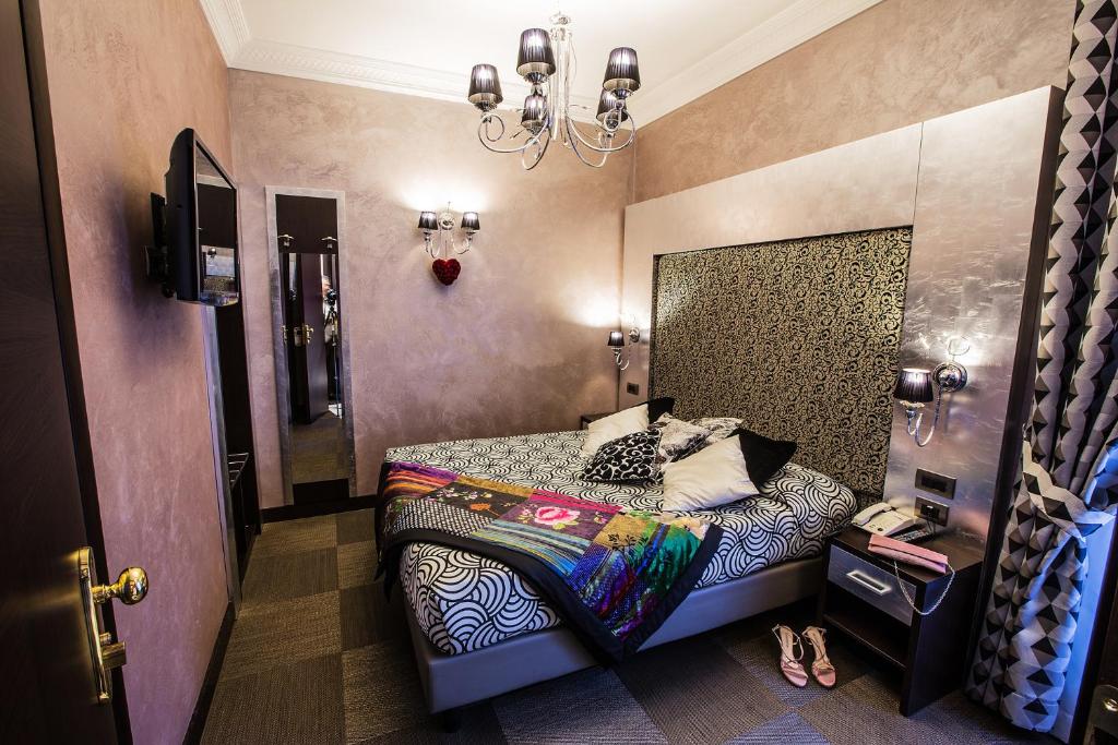 Postel nebo postele na pokoji v ubytování Hotel Romano