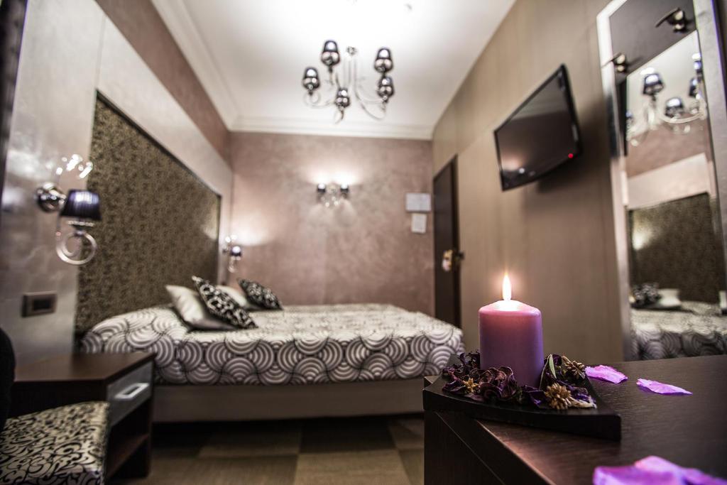 Postel nebo postele na pokoji v ubytování Hotel Romano