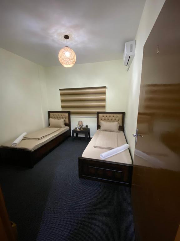 a room with two beds and a table in it at Hustle's look in Wadi Musa
