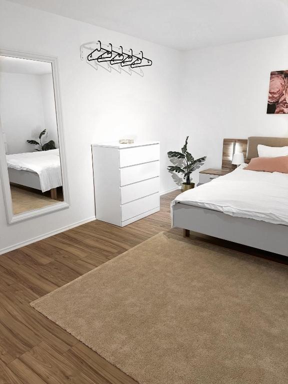 a bedroom with a bed and a large mirror at Eine schöne Wohnung im Herzen von Basel. in Basel