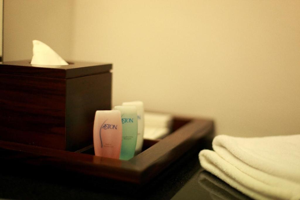 Postel nebo postele na pokoji v ubytování Aston Tanjung City Hotel
