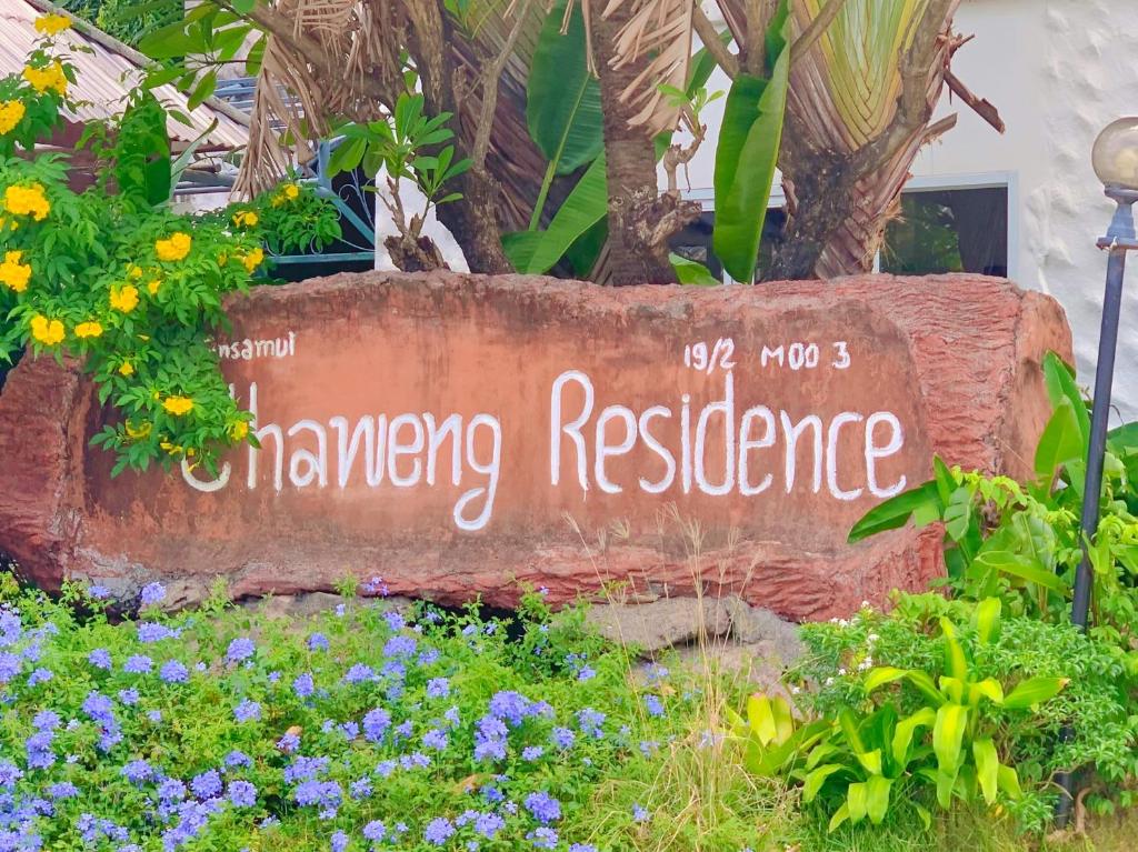 a sign for a hawking residence in a garden at Chaweng Residence in Koh Samui