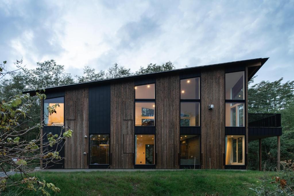 a modern house with a black roof at Furano Peak in Furano