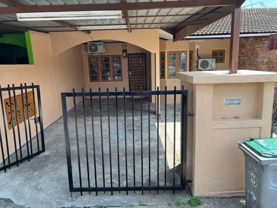 an entrance to a building with an iron gate at Indah Homestay, Pasir Gudang Johor in Pasir Gudang