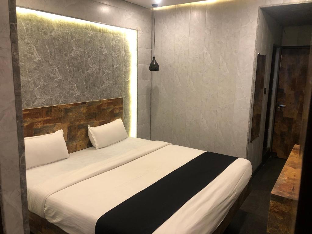 Postel nebo postele na pokoji v ubytování Aariv Inn BAGA BEACH