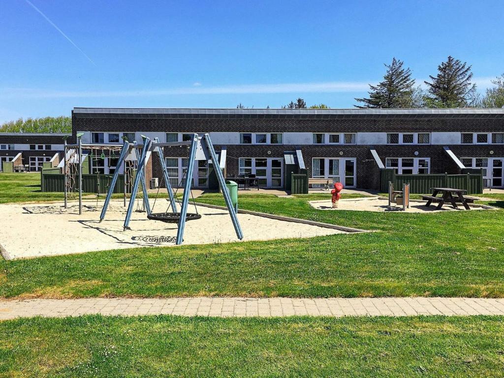 an empty playground in front of a building at Holiday home Hemmet CIII in Hemmet