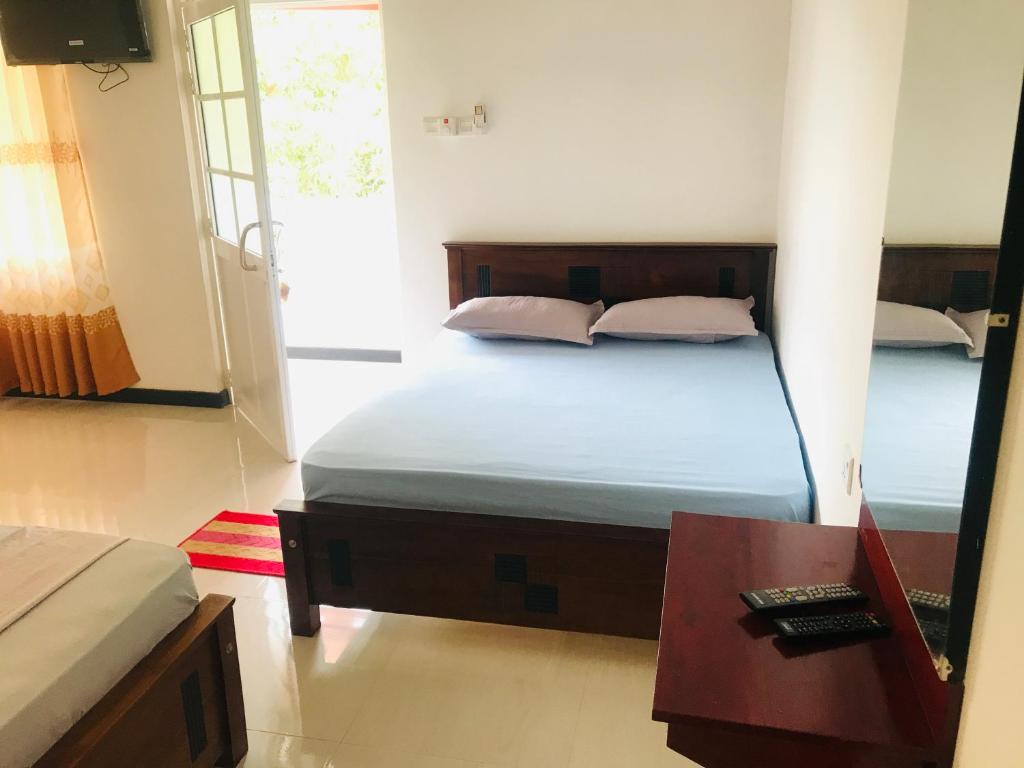 Postel nebo postele na pokoji v ubytování Hotel Ganthera Kataragama
