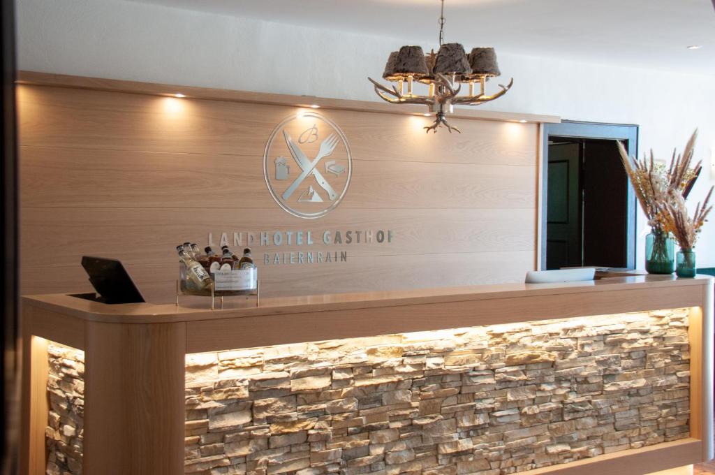 a lobby of a hotel with a stone wall at Landhotel & Gasthof Baiernrain in Baiernrain