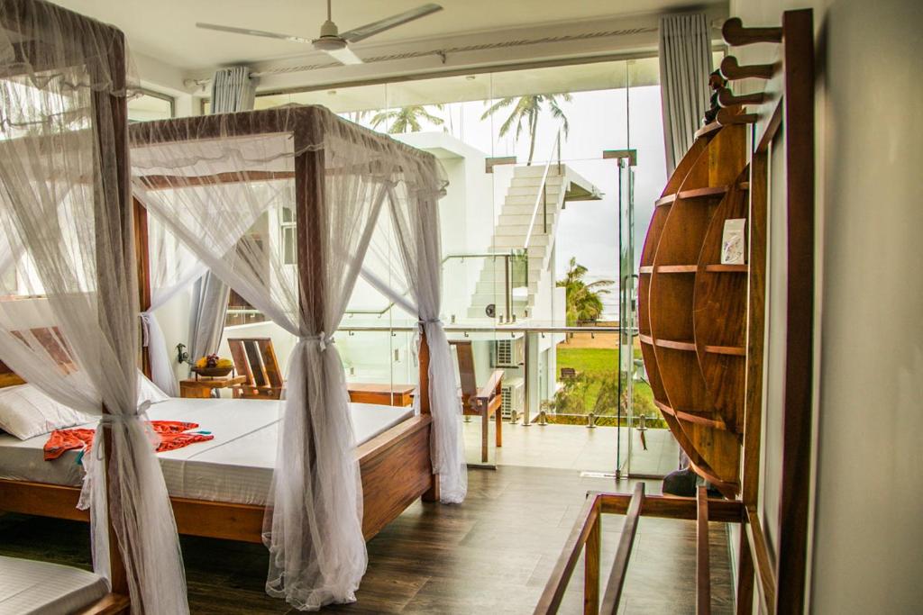 Postel nebo postele na pokoji v ubytování Infinity of Sri Lanka