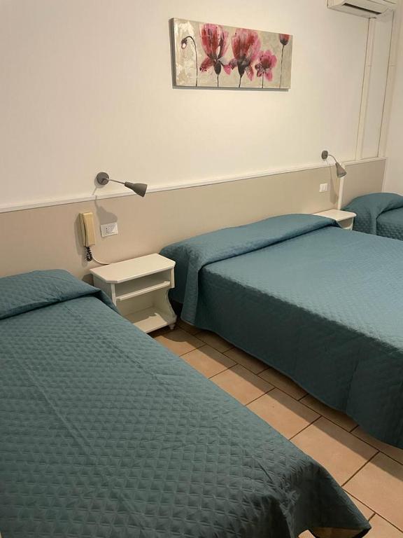 Postel nebo postele na pokoji v ubytování Hotel Garni Tosca