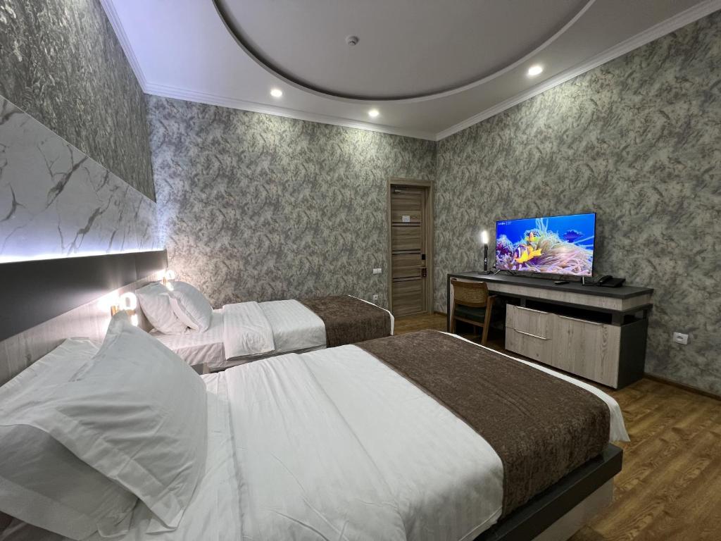 Postel nebo postele na pokoji v ubytování Ada Hotel